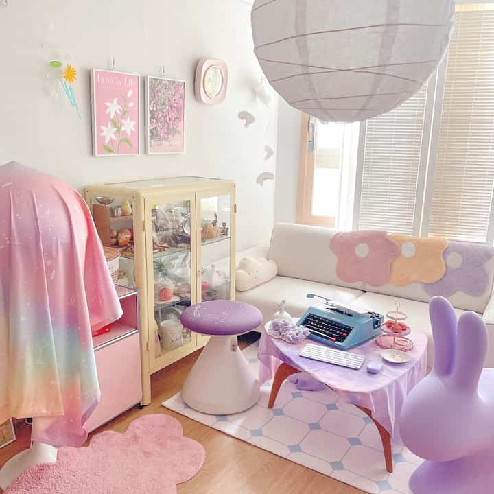 Bright pink and purple toned living space with cozy sofa, adorable decor, evoking a charming baby room atmosphere