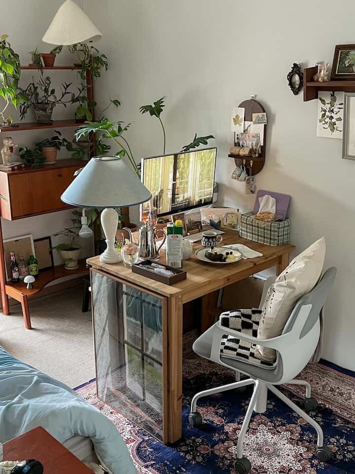 Natural wood tone home office space featuring vintage decor, plants, and cozy lighting to create a warm atmosphere