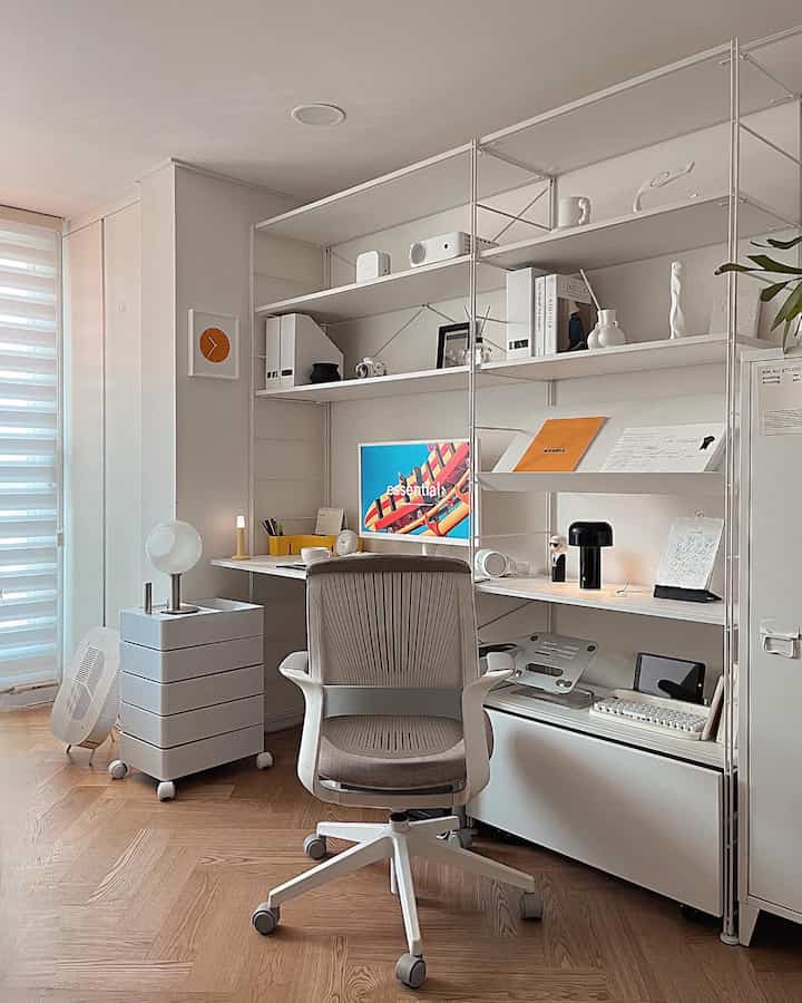 Modern home office with white and wood tones, featuring a minimalist desk and office chair in a clean space