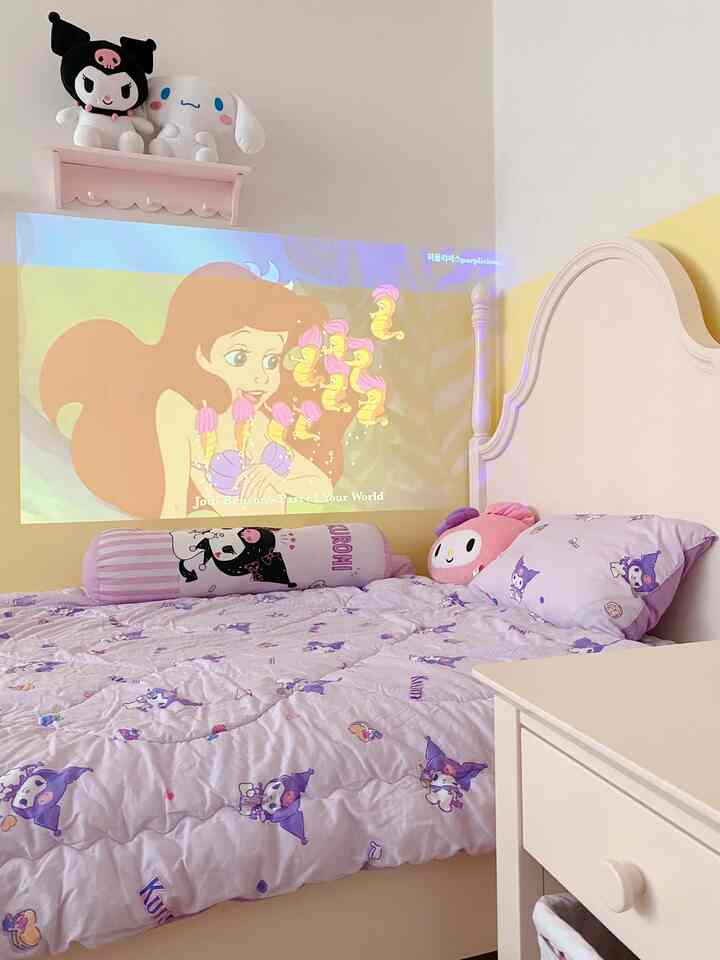 Pink and light brown toned kids' bedroom featuring character bedding and a projector screen, creating a cozy atmosphere