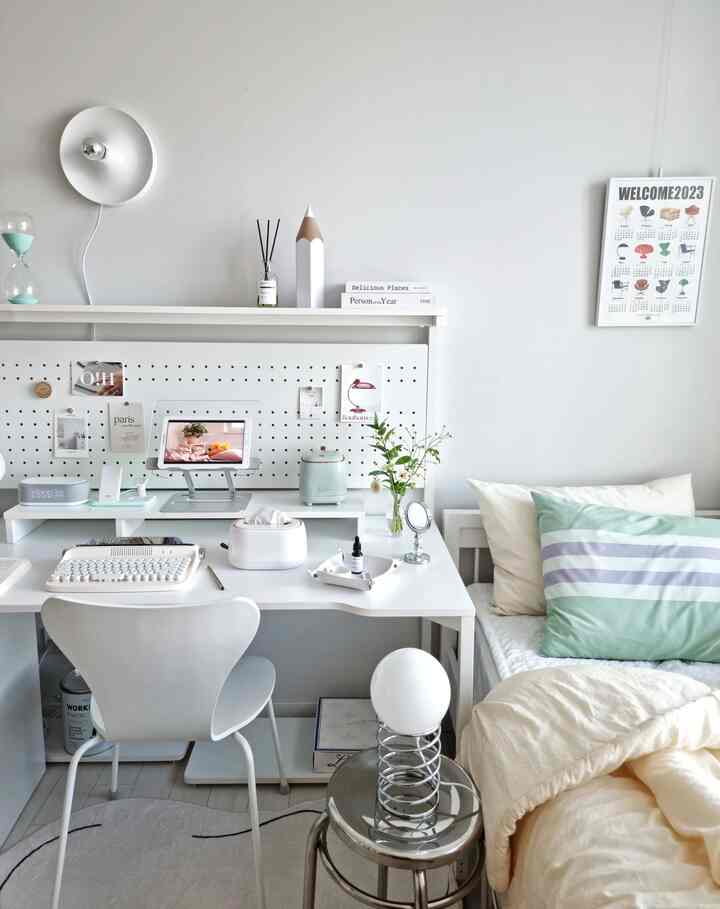 White-toned kids' room featuring a desk and bed arranged neatly with a cozy atmosphere