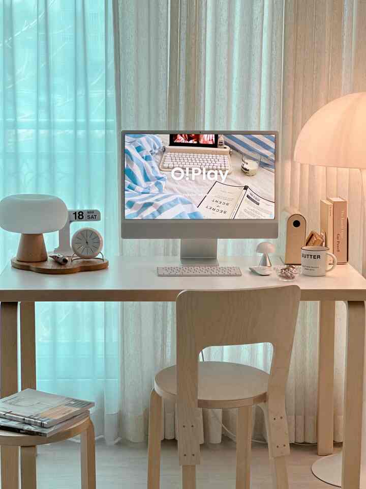 Bright white and light wood tone home office featuring iMac and wooden desk with chair, showcasing a clean natural modern interior