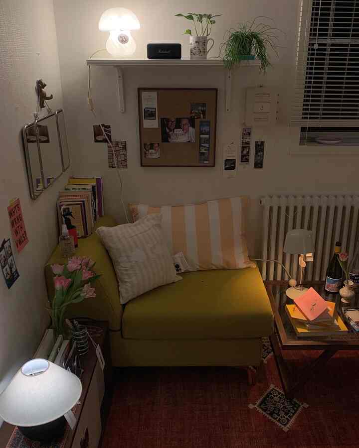 Cozy living room corner with yellow-green sofa and natural plants