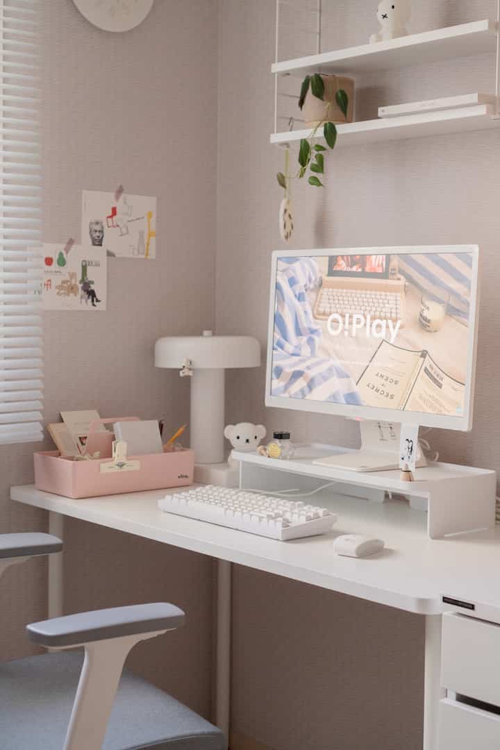 Bright white-toned home office space featuring a neat desk with a white Kikron keyboard and monitor stand in a stylish study interior