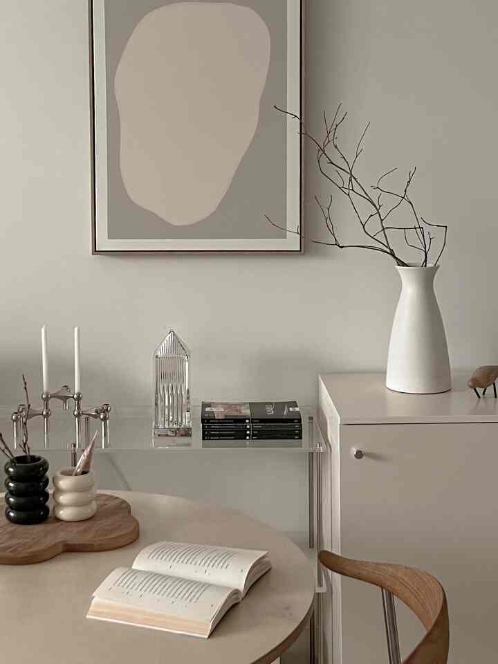 Warm natural beige-toned living room featuring natural wood furniture and simple decorative objets creating a cozy atmosphere.
