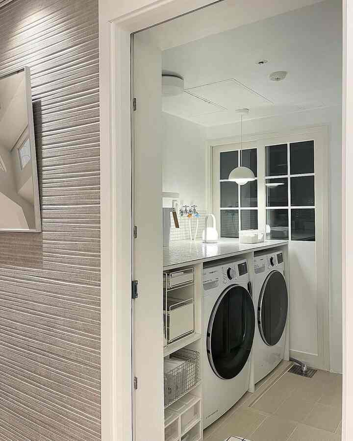 White-toned laundry room featuring LG washer and dryer with simple storage shelves in a clean space