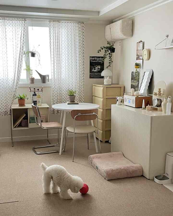 Ivory and white toned living room featuring dining table, dresser, natural modern style with a dog and pet bed creating a cozy atmosphere