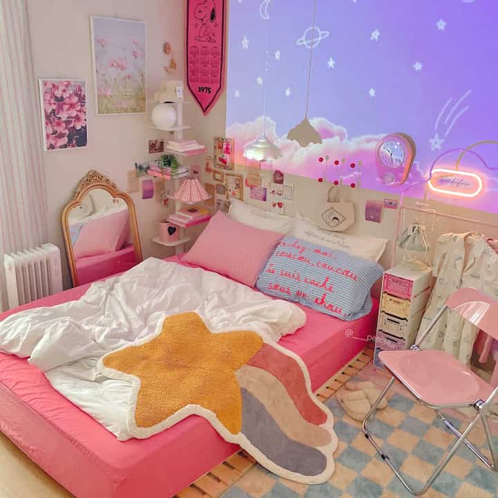 Pink and white toned bedroom featuring star-shaped rug, wall clock, and cozy decorative elements