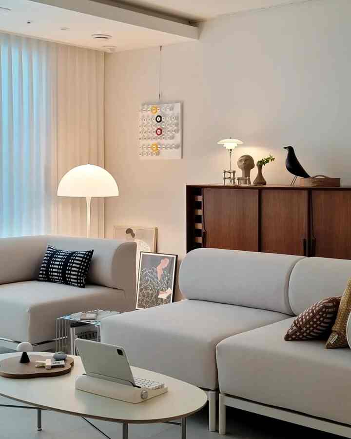 Natural modern living room in soft beige tones featuring beige sofas, wooden console cabinet, and floor lamp