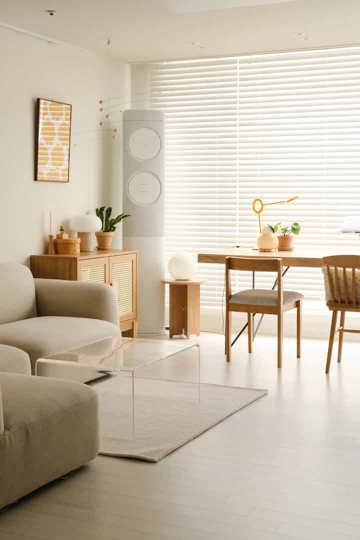 Bright living room featuring natural wood tones and beige sofa with a simple, clean design