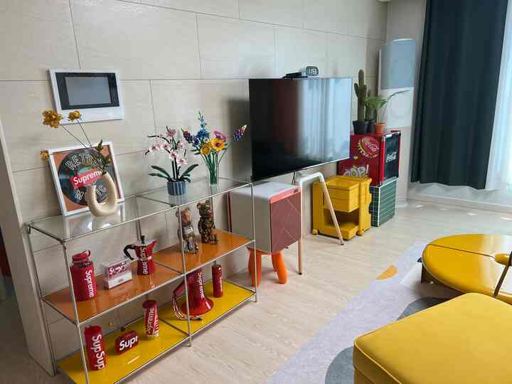 Modern living room in yellow tones featuring yellow sofa and retro-themed decor items