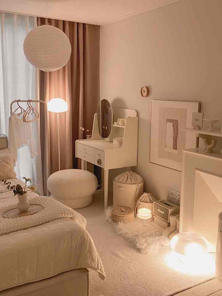 Warm beige bedroom featuring vanity, plush curtains, and cozy lighting creating a comfortable atmosphere