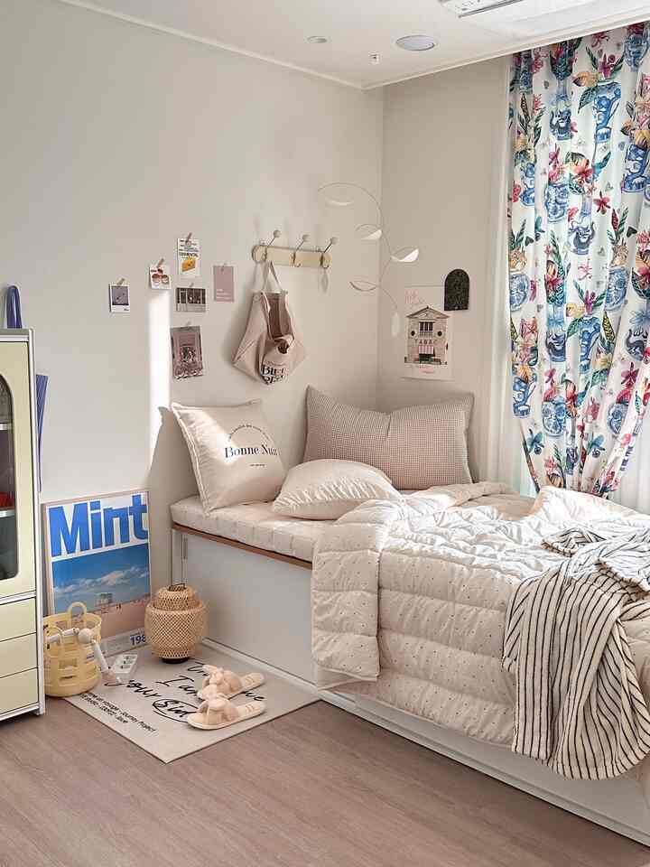 Beige and natural-colored compact bedroom featuring a storage sofa bed with cozy decor items creating a comfortable atmosphere