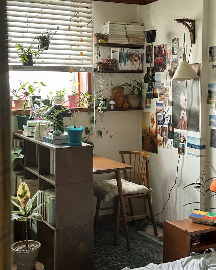 Natural-toned compact workspace featuring wooden furniture and abundant plants, creating a cozy atmosphere