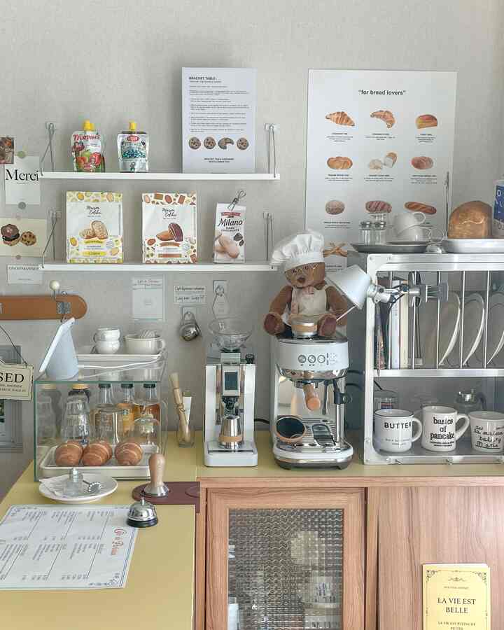 Natural and white toned living room style home cafe featuring coffee machines and bakery accessories with a cozy atmosphere