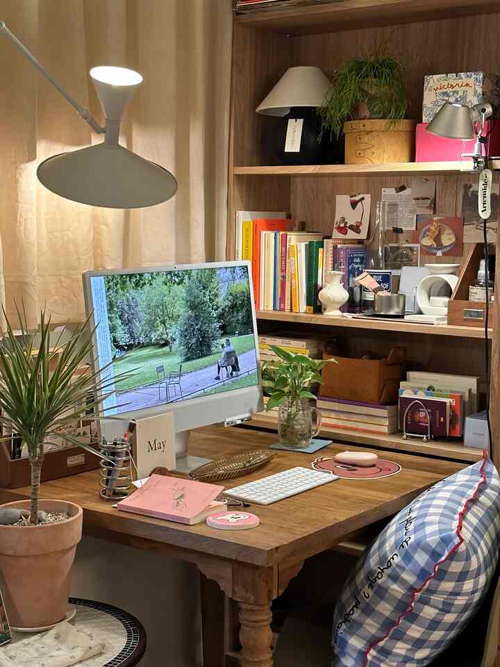 温かみのある木目調と白色が調和した寝室のデスク空間、書棚と植物が配された雰囲気のあるホームオフィス