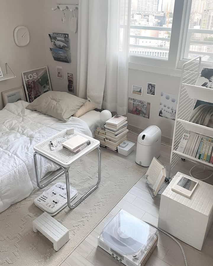 White and natural-toned single household study space featuring books and reading lamp with clean modern interior