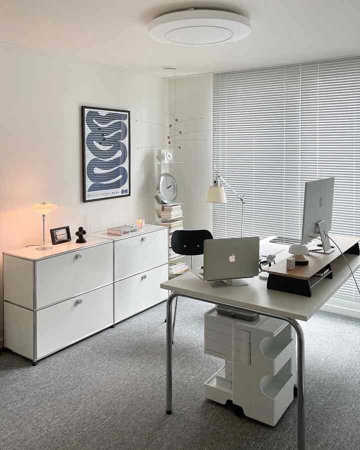 White-toned study home office featuring a USM sideboard and a desk with computer monitors, arranged in a modern style