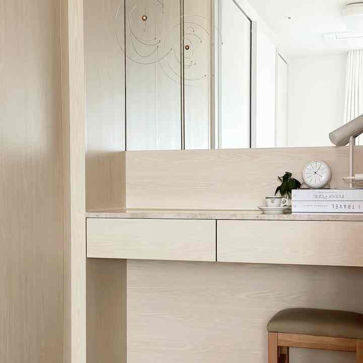 Beige and white toned powder room vanity with minimal accessories and neat storage showcasing a clean space