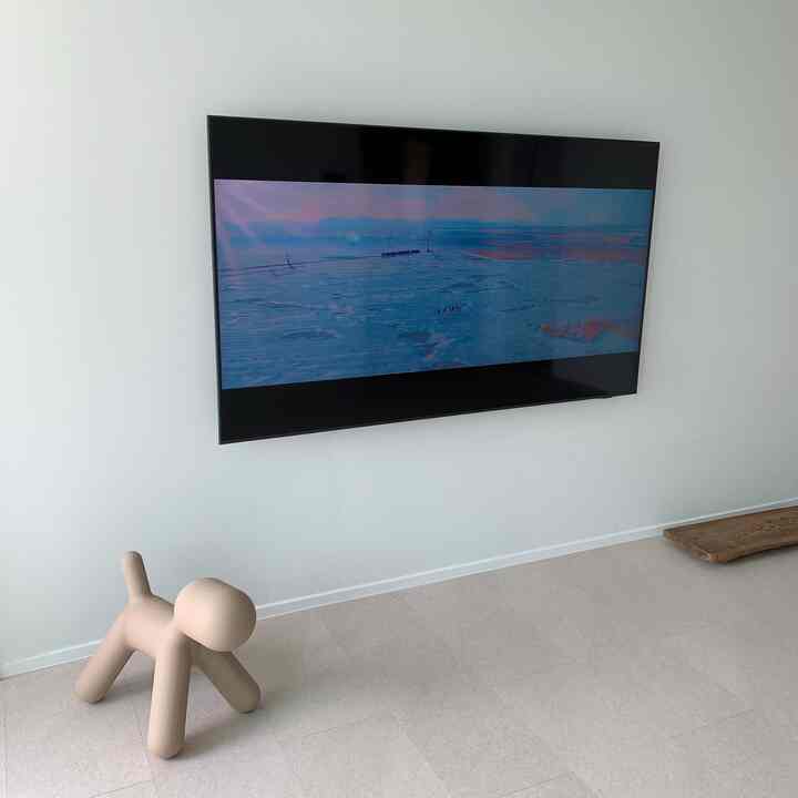 Beige and white tone living room featuring a Magis Puppy sculpture on the floor in a stylish minimalist space