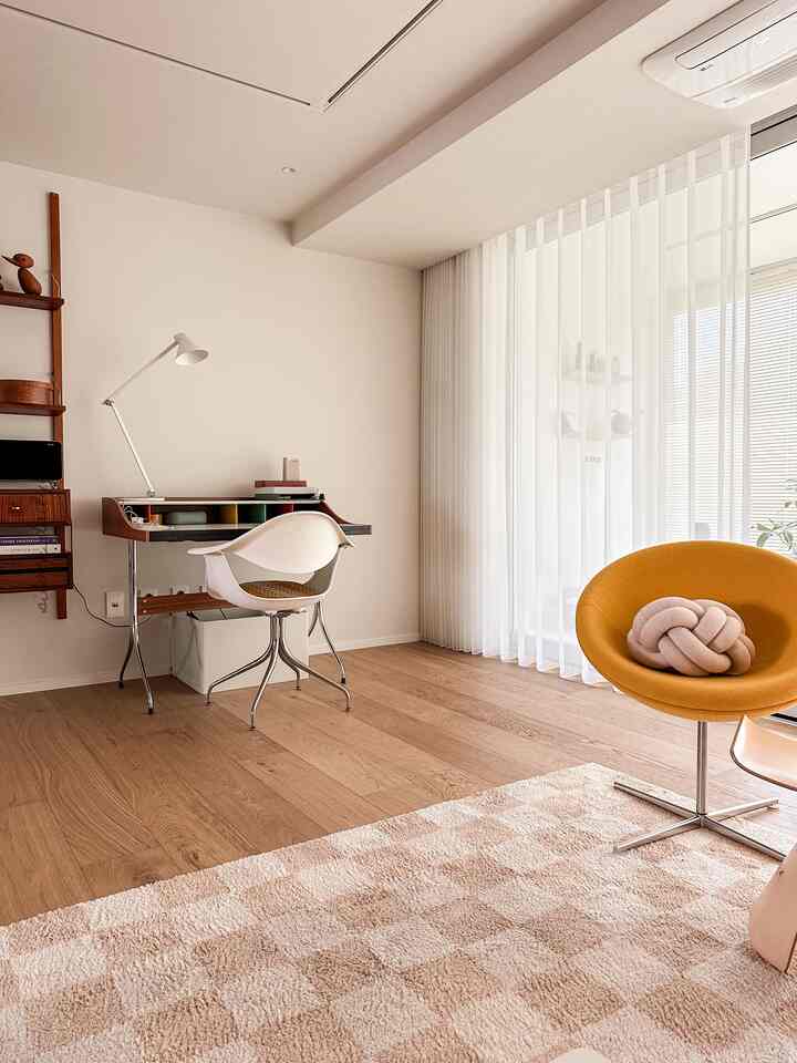 Natural-toned living room featuring wood flooring and vintage desk, creating a cozy and calm atmosphere