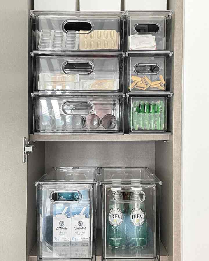 Transparent storage drawers neatly arranged inside pantry, showcasing an organized kitchen area with efficient space use