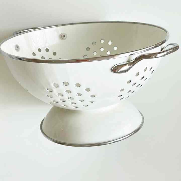 Clean white-toned kitchen colander with a minimalist and neat design objet