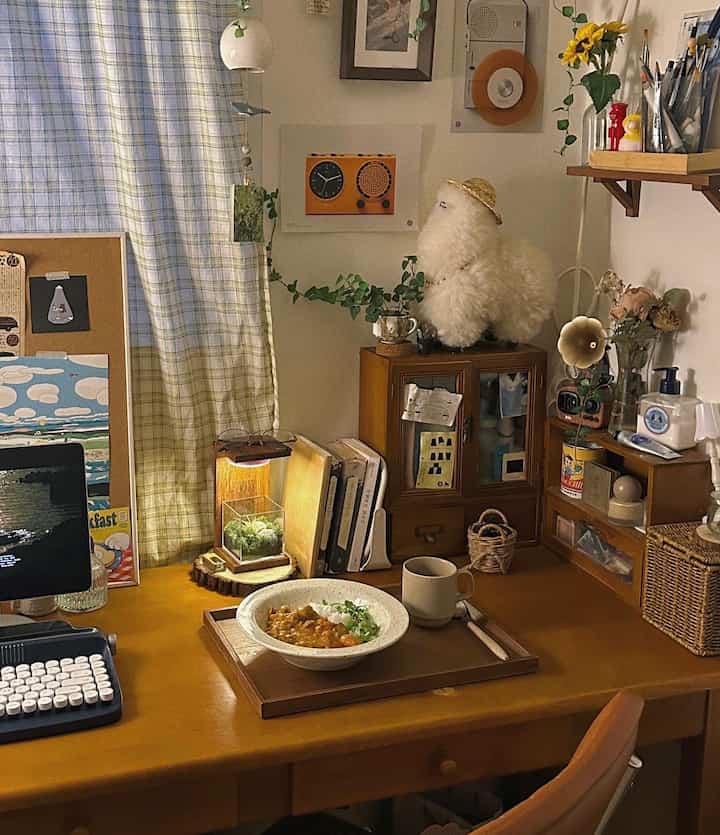 Warm yellow wood-tone desk space, combining dining and workspace elements with cozy home cafe atmosphere