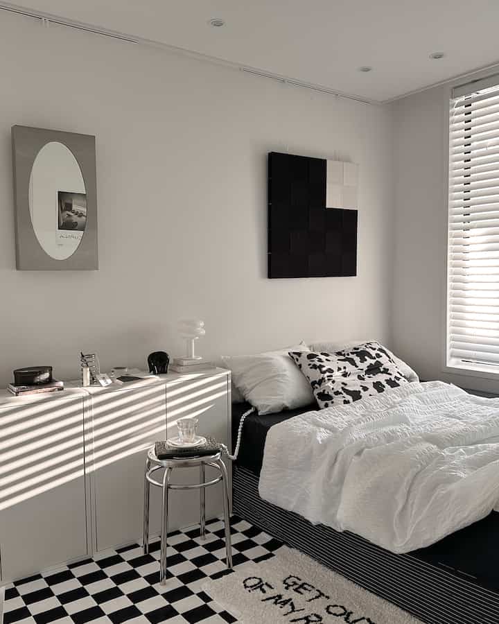 Monotone black and white compact bedroom featuring minimalist furniture and simple decor in a modern style