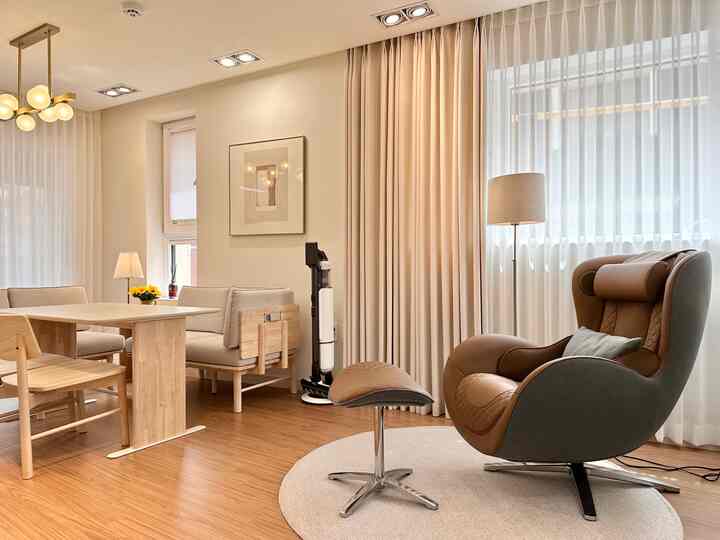 Beige and wood-tone compact living room featuring a recliner and dining table with cozy and refined atmosphere