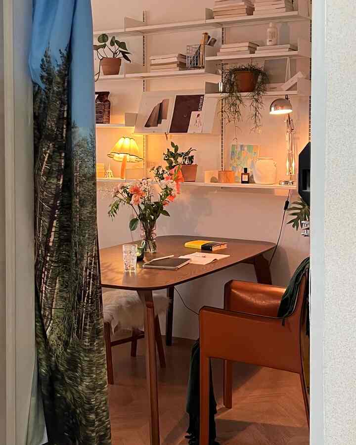 Cozy dining room in warm natural tones featuring wooden table and brown armchair with soft ambient lighting