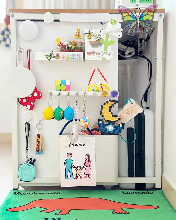 明るいホワイトとナチュラルカラーの子供部屋、マグネット棚やフックで小物を整理した雰囲気のある収納空間