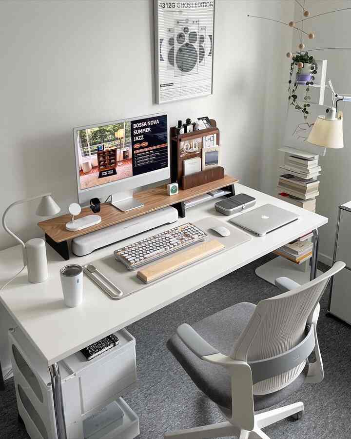 White and gray toned home office space featuring a clean desk and office chair in a minimal desk setup