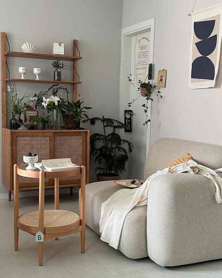 Beige sofa and rattan wood tone furniture in a natural and simple living room space