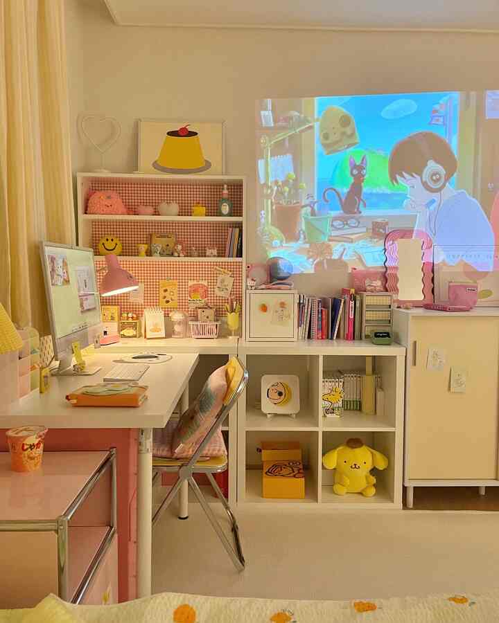 White and pink toned kids' room featuring IKEA desk and bookshelf with a projector display on the wall for a cozy study space