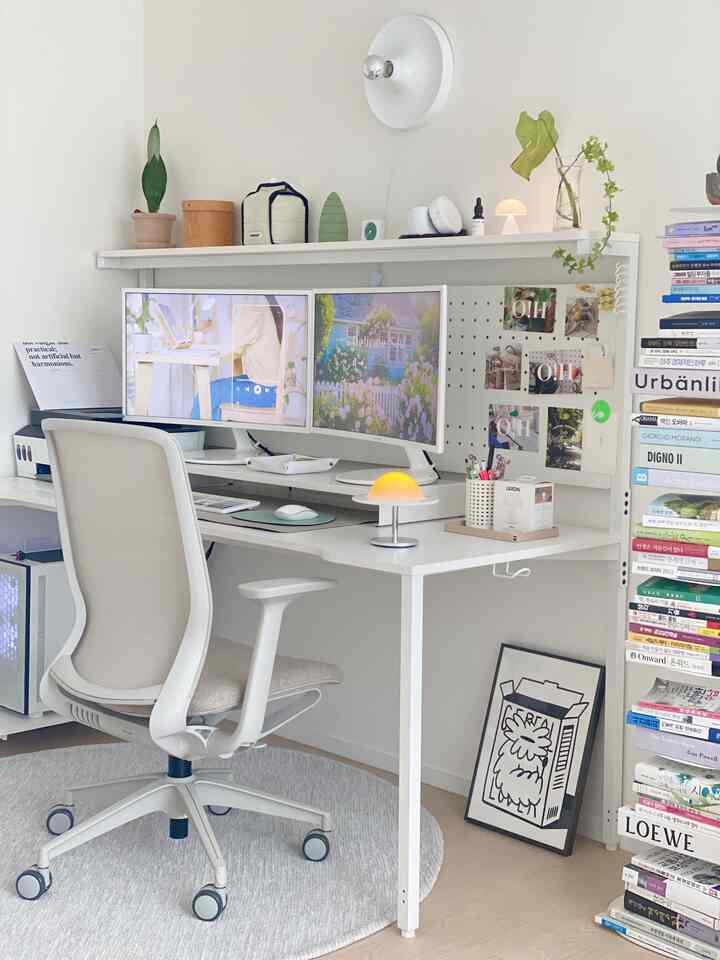 White and natural toned home office featuring dual monitors, ergonomic chair, and minimalist workspace setup