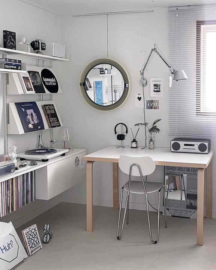 Bright white tone home office featuring an Artek table and bookshelf in a mid-century modern style interior
