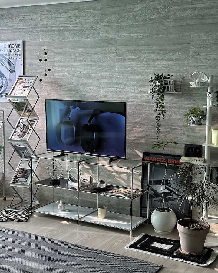 Gray-toned wall with metal TV stand, shelves, and poster featured in a Mid-Century Modern living room space