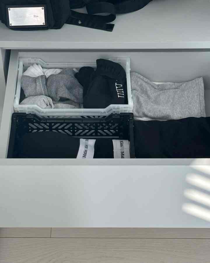 White and gray monotone closet drawer interior featuring neatly organized socks and underwear in folding boxes