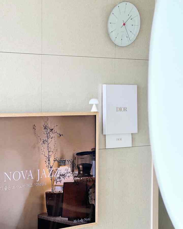 Simple and minimal living room wall with light beige wall and wood frame artwork