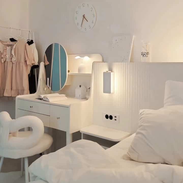 White-toned middle school girl's room featuring a vanity and bed in a cozy, emotional atmosphere