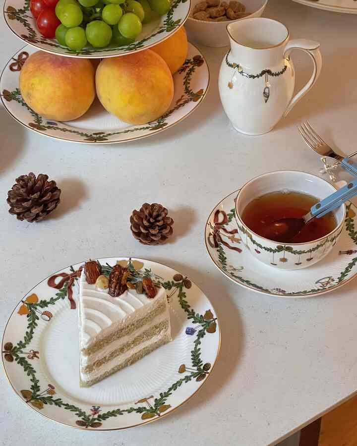 Light natural toned ceramic table featuring tea set and plates arranged for tea time enjoyment.