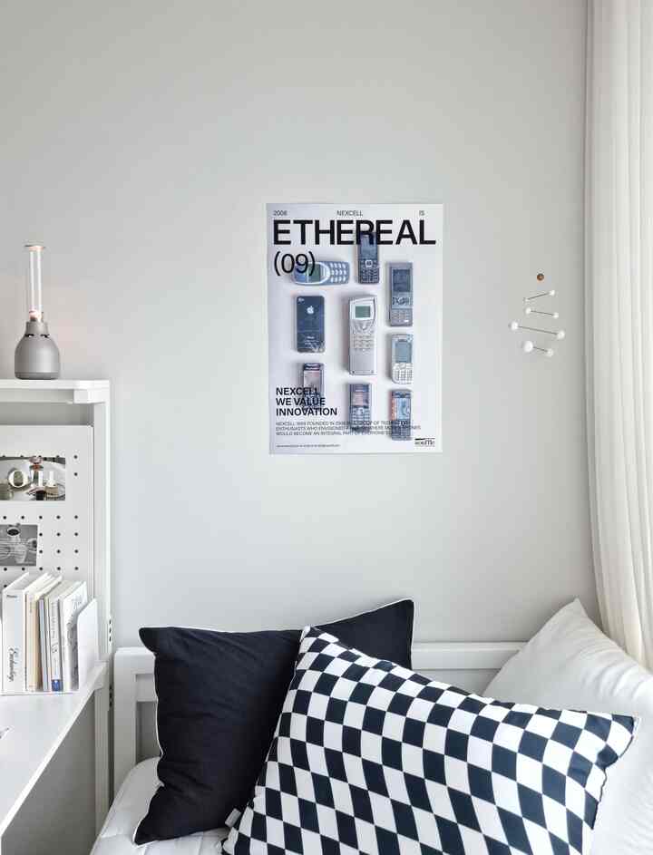 A white and monotone living room featuring white curtains and black & white checkered pillows in a simple interior space