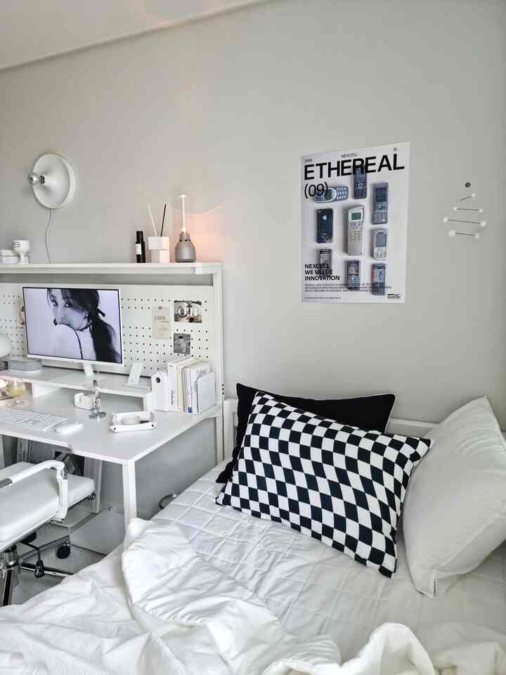 White-toned kids' room featuring modern desk and bed in a simple, clean space