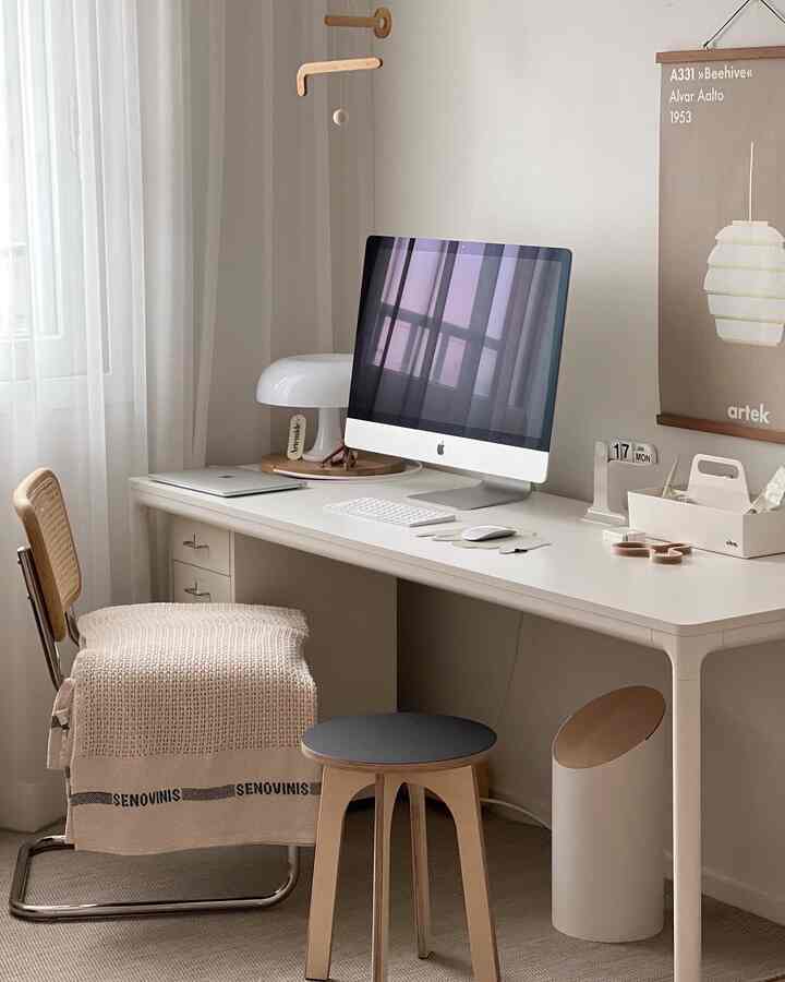 White and wood-toned study-style home office space featuring minimalist desk and natural elements