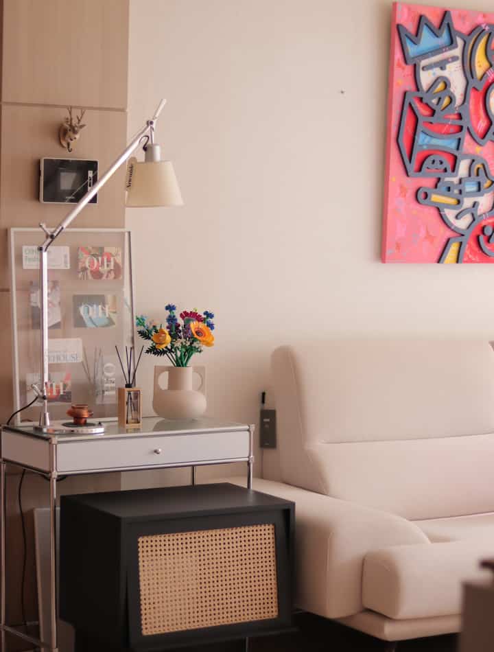 Natural color and wood tone living room featuring beige sofa, side tables, and a Lego flower bouquet, creating a cozy atmosphere