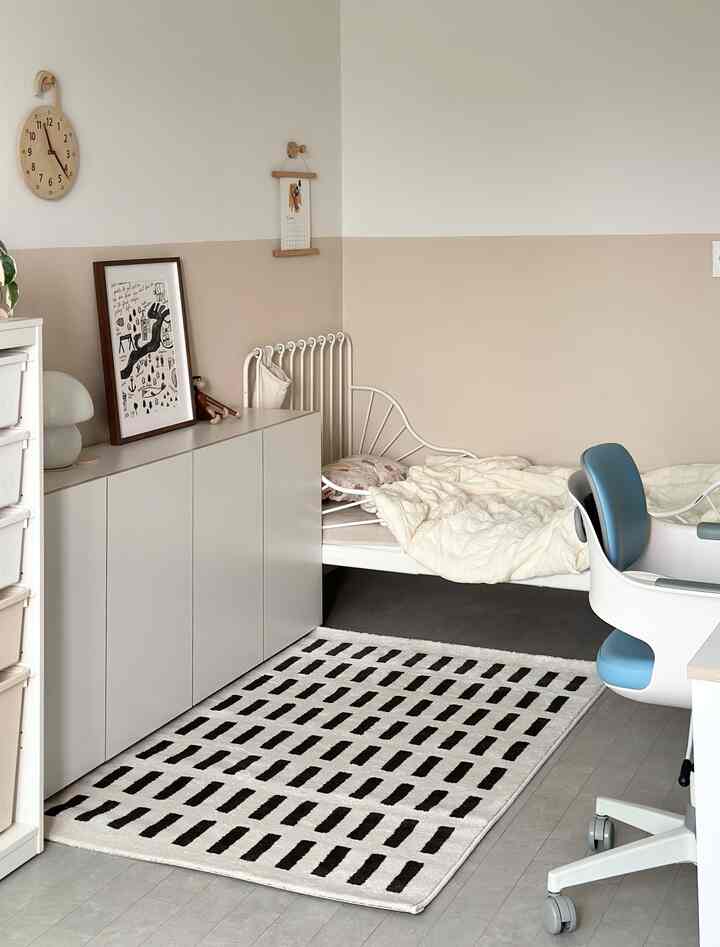 White and beige toned bedroom featuring modern cabinets, desk, and office chair in a cozy setting