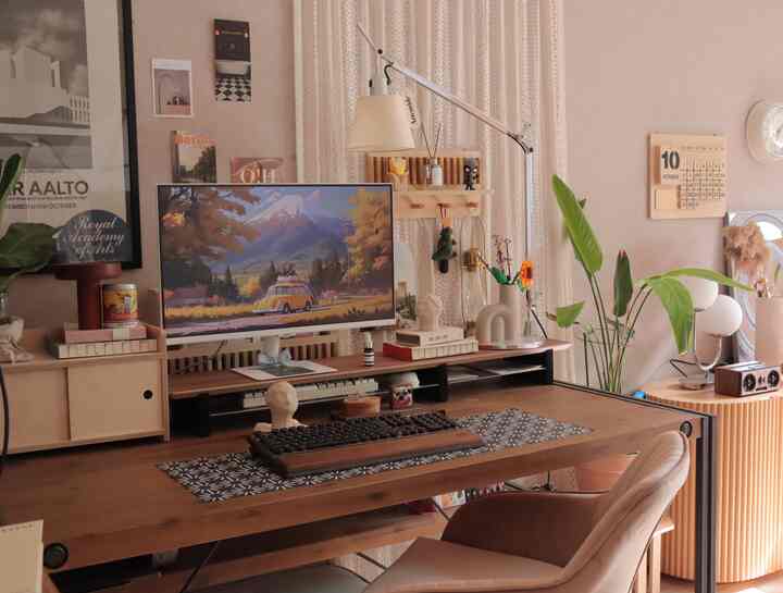 Cozy natural tone home office featuring wooden desk, monitor, and beige lace curtains with ambient lighting
