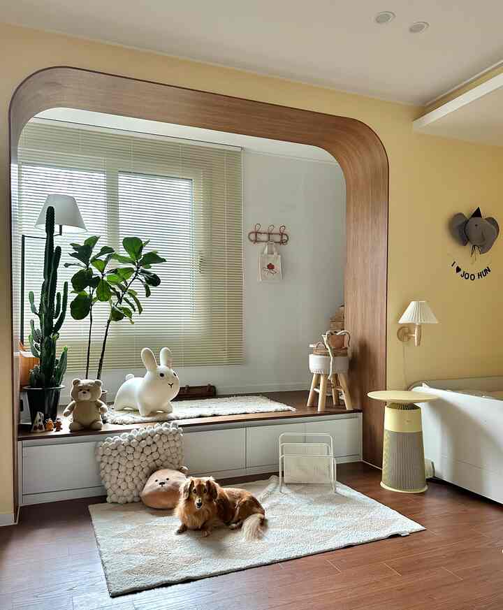 Beige and wood-toned kids' bedroom with a dog and various toys creating a cozy atmosphere