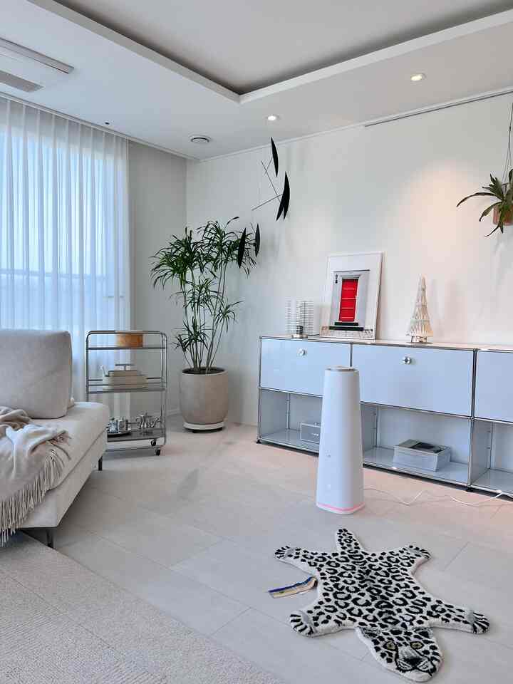 White and natural tone living room featuring beige sofa and modern storage cabinets with a clean atmosphere